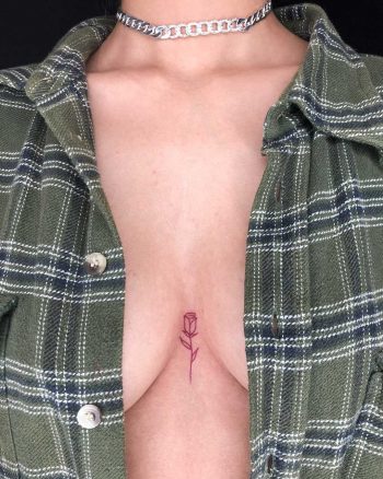 Tiny red rose on a sternum by Loz Thomas