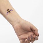 Bee tattoo on a wrist by Rey Jasper