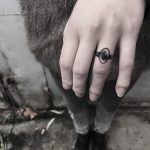 Black ring tattoo by Krzysztof Szeszko