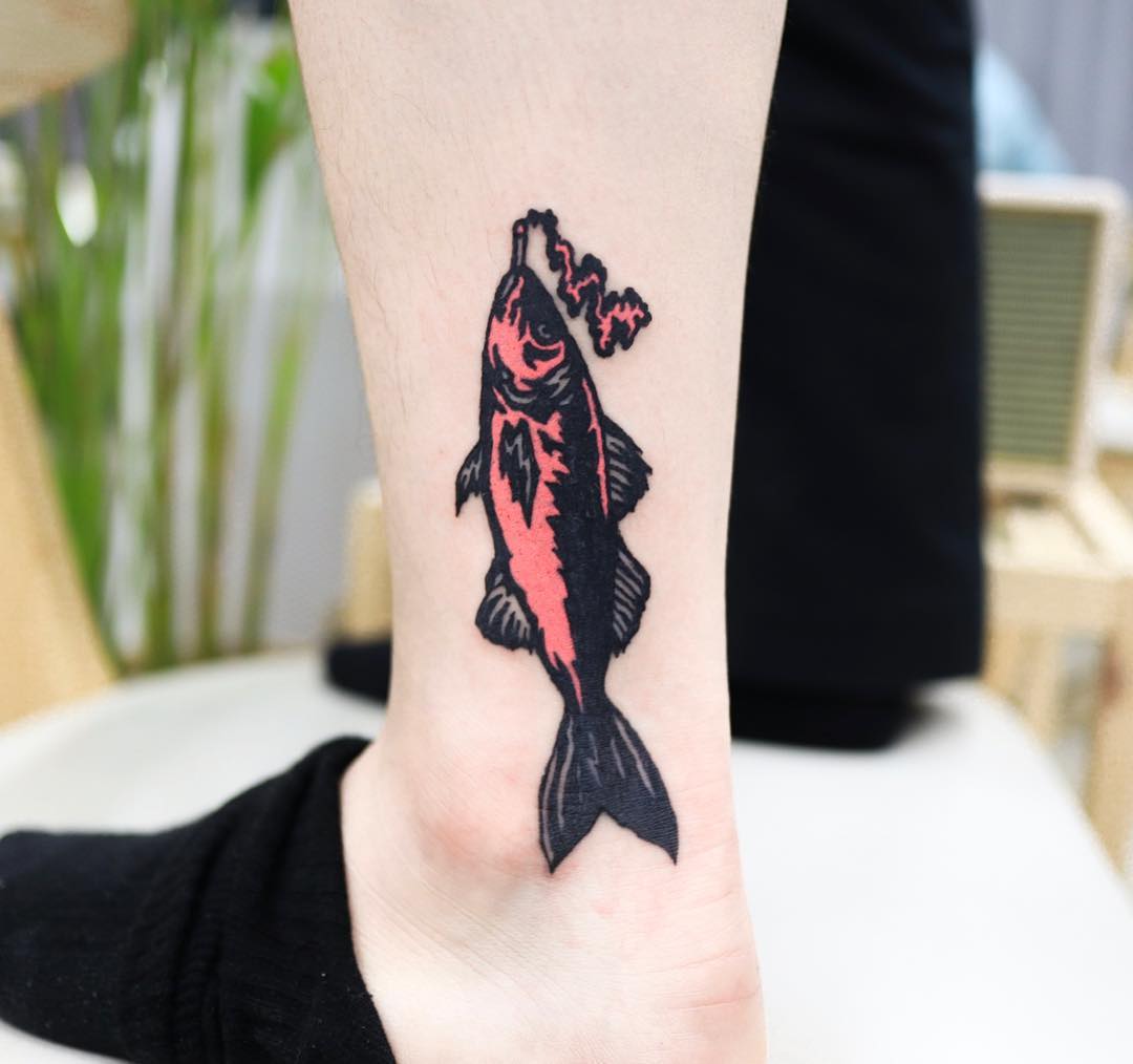 Cover-up fish tattoo by Puff Channel