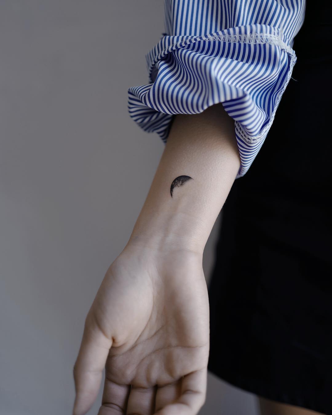Crescent moon on a wrist by Studio Bysol