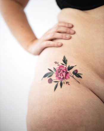 Flower tattoo on a hip by Rey Jasper