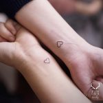 Matching tiny heart tattoos by Nudy tattooer