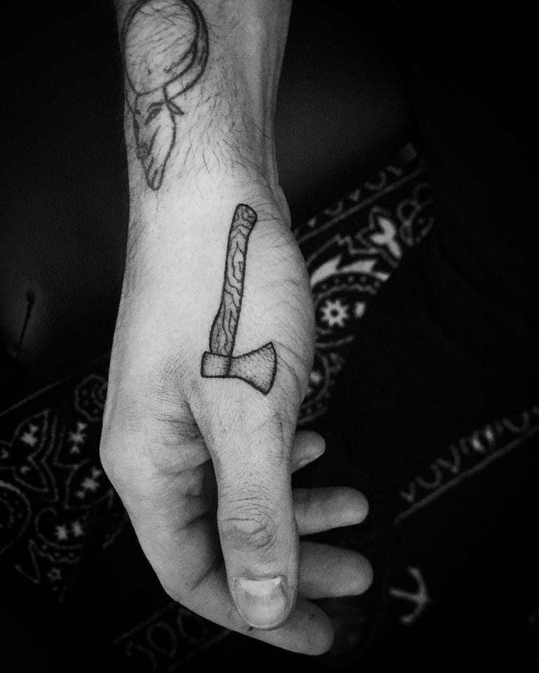 Small ax tattoo by Philipp Eid