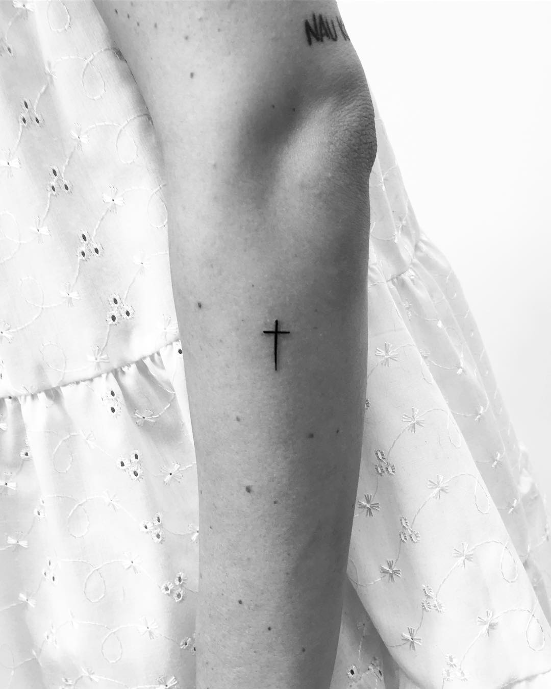 Small cross tattoo by Philipp Eid
