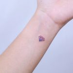 Tiny diamond on a wrist by tattooist Nemo