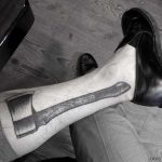 Axe tattoo on a calf by tattooist Oozy