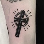Black cross by tattooist yeontaan