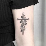 Floral cross by Nudy tattooer