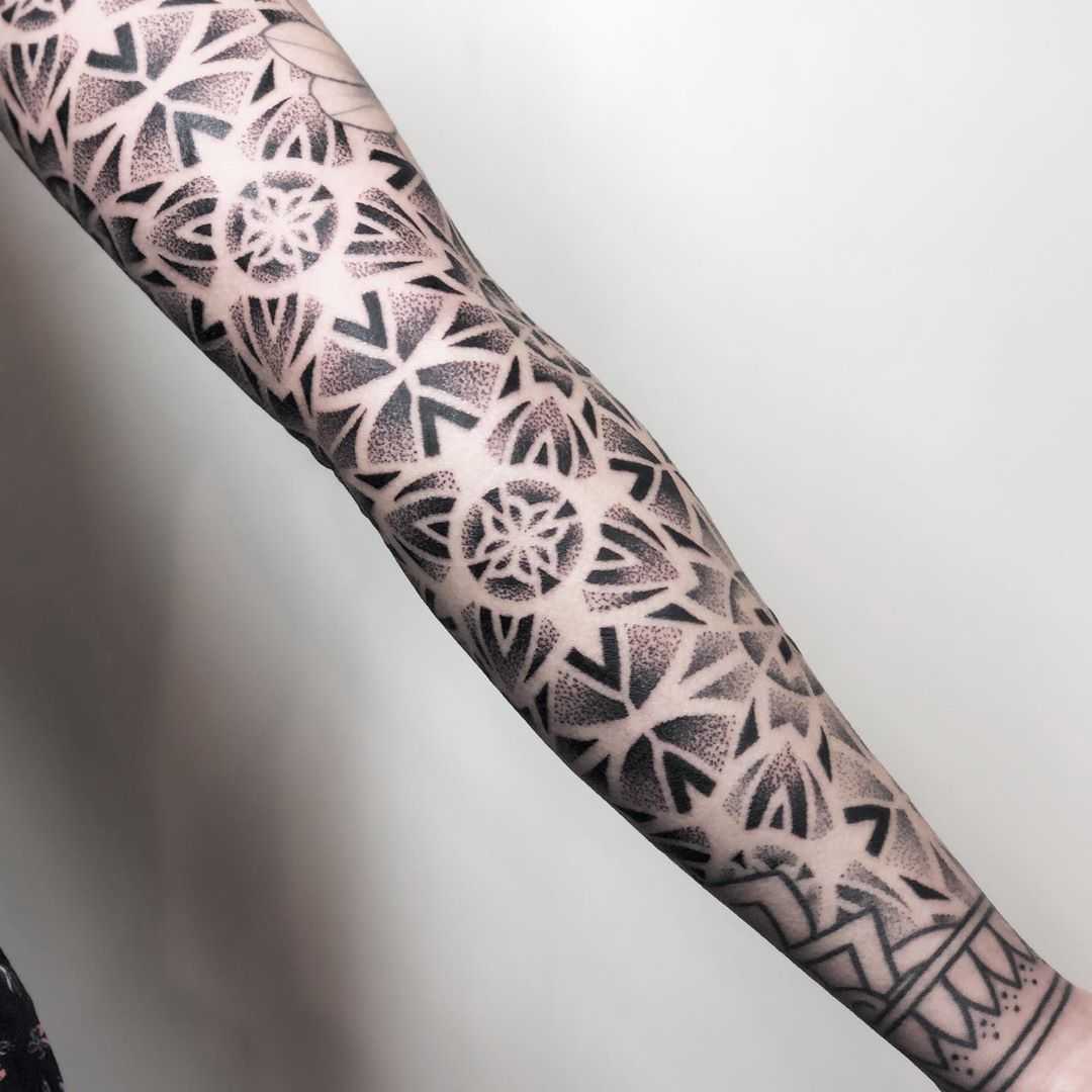Geometric sleeve tattoo by Remy B