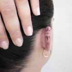Ornamental ear tattoo by Remy B