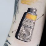 Photorealistic paint tube tattoo by Mumi Ink