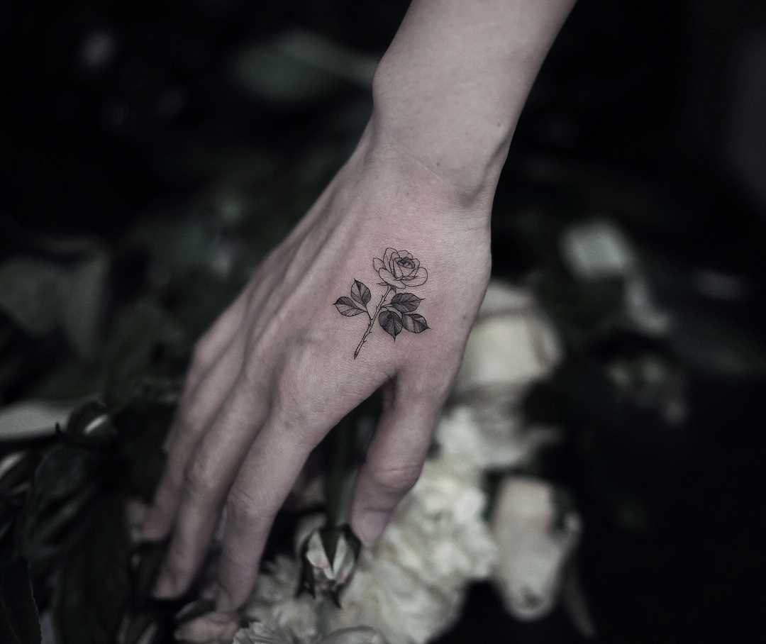Small rose on a hand by tattooist Goyo