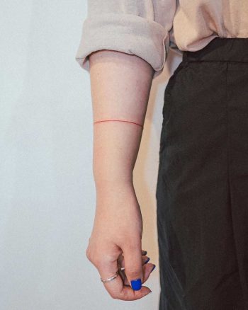 Thin red bracelet tattoo by tattooist Bongkee