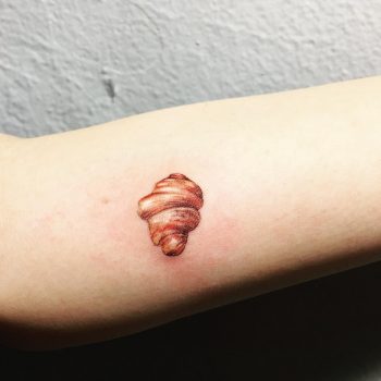 Tiny croissant by tattooist Cozy