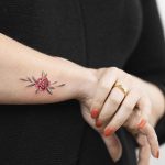 Tiny peony flower tattoo by Rey Jasper