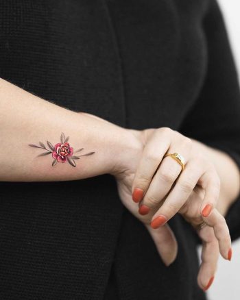 Tiny peony flower tattoo by Rey Jasper