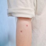 Two tiny hearts by tattooist Nemo