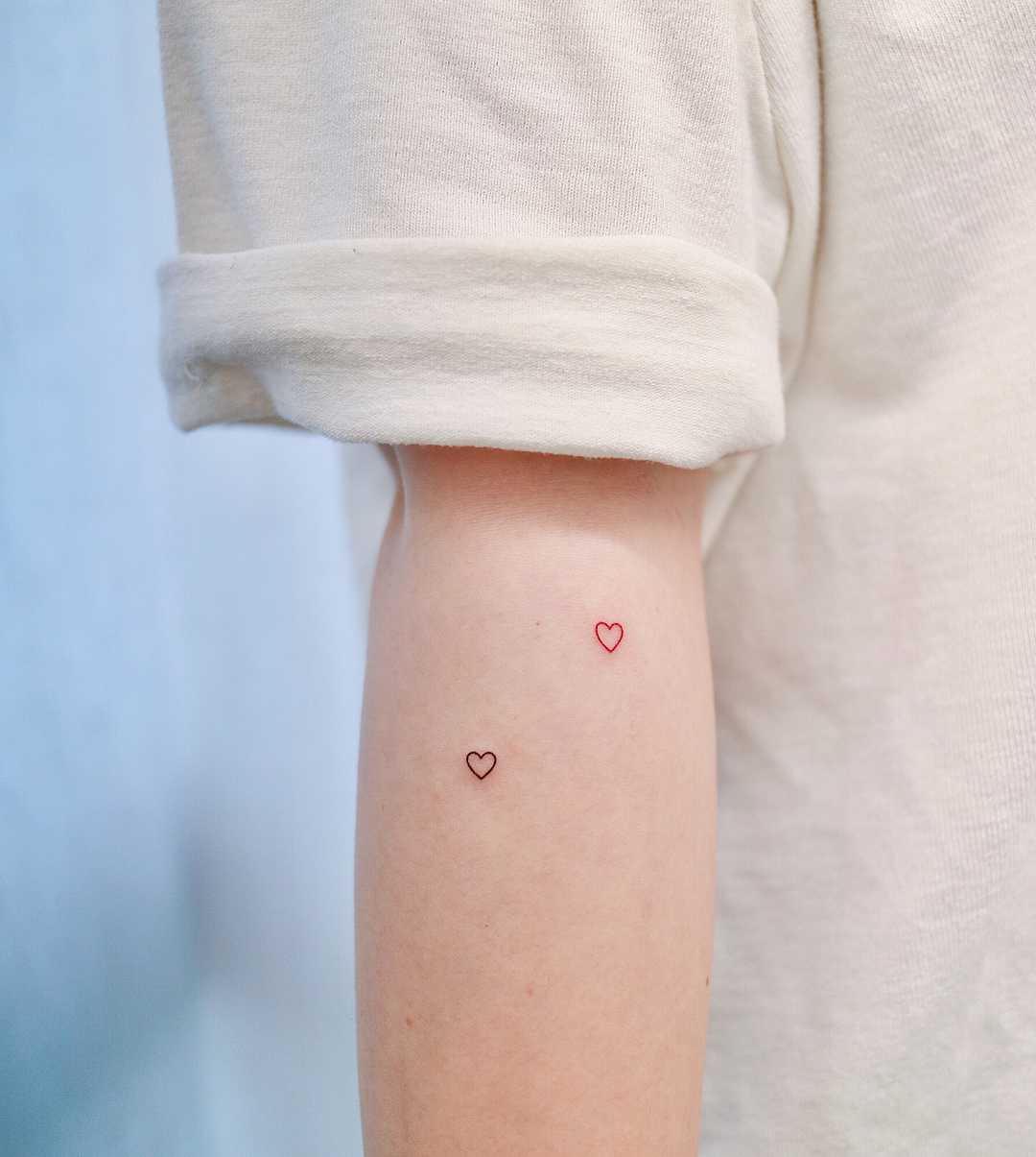 Two tiny hearts by tattooist Nemo