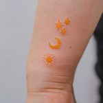 Yellow sun, moon, and stars by tattooist Bongkee