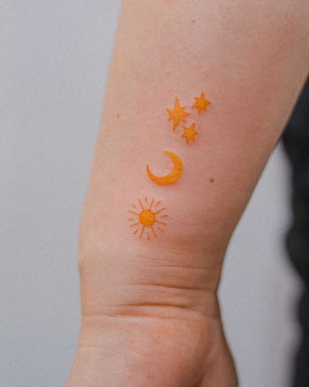 Yellow sun, moon, and stars by tattooist Bongkee