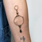 Antique monocle tattoo by Mumi Ink
