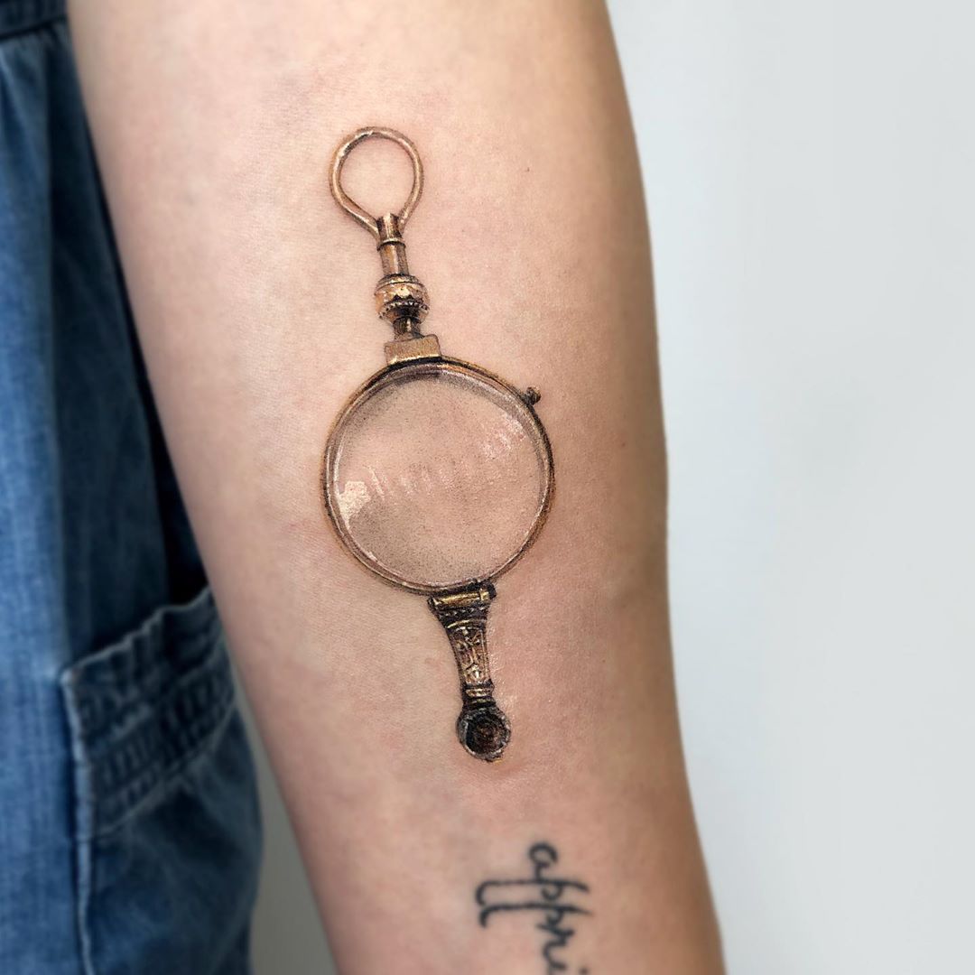 Antique monocle tattoo by Mumi Ink