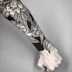 Black and white forearm by tattooist MAIC