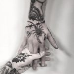 Black tattoos on a hand by tattooist weepandforfeit