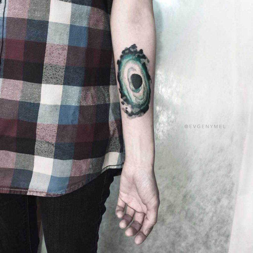 Spinning top tattoo by artist Cholo