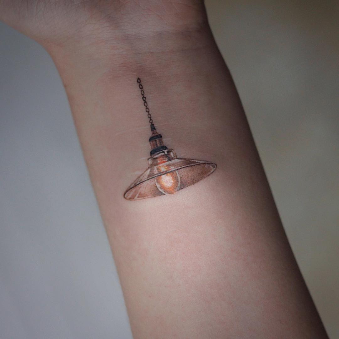 Hanging lamp tattoo by tattooist Saegeem