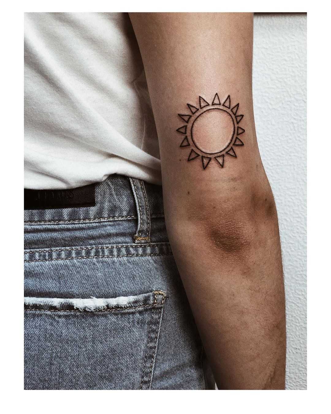 Moon and sun circular tattoo on the inner arm - Tattoogrid.net