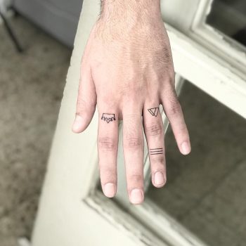 Tiny tattoos on fingers by Sara Kori