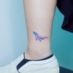 Watercolor whale on an ankle by tattooist Ida