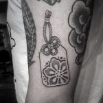 Little omamori tattoo by tattooist Virginia 108