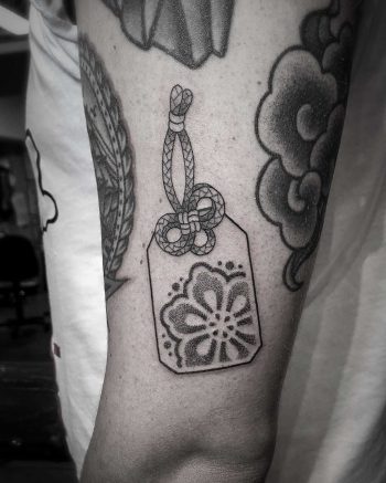 Little omamori tattoo by tattooist Virginia 108