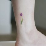 Purple tulip on an ankle by tattooist Saegeem