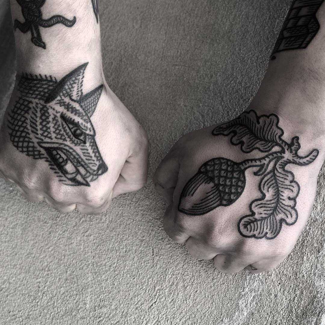 Wolf and acorn by tattooist MAIC