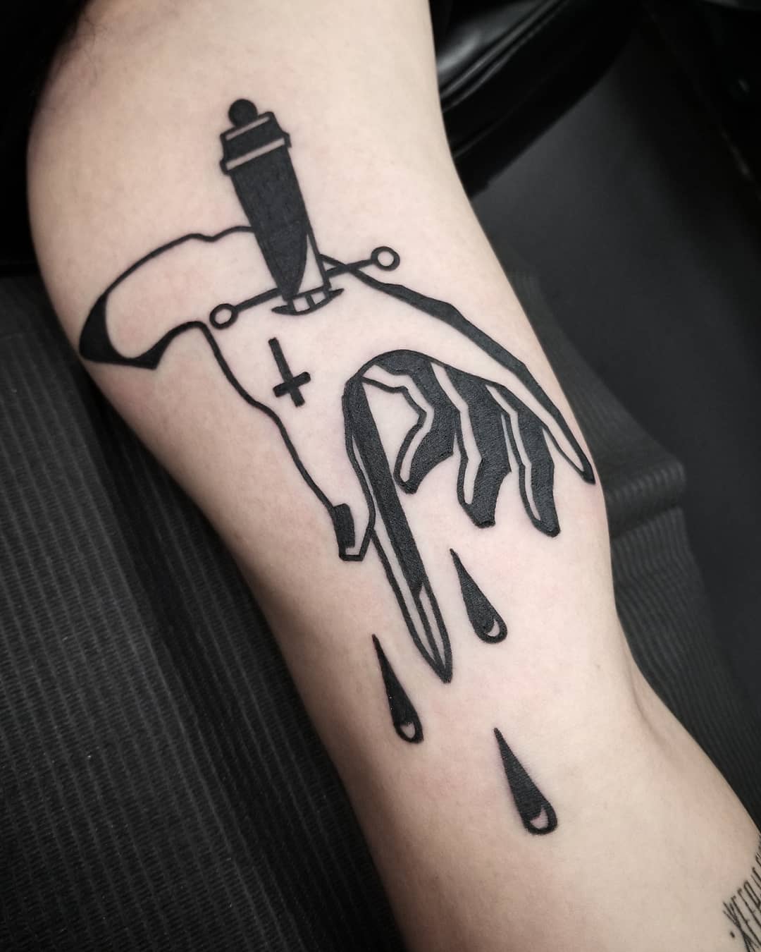 Dagger pierced hand by @thomasetattoos