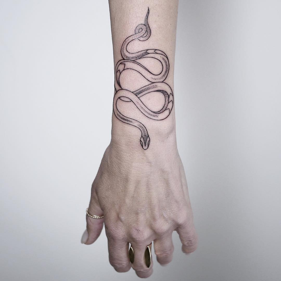 Snake on a forearm by @mariafernandeztattoo
