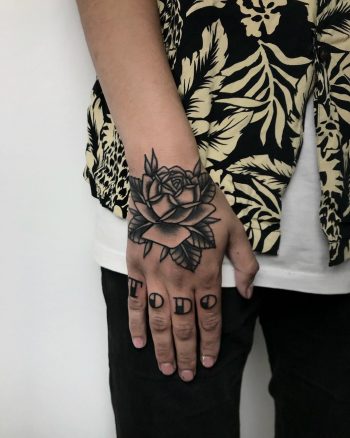 Black rose on a hand by @tototatuer