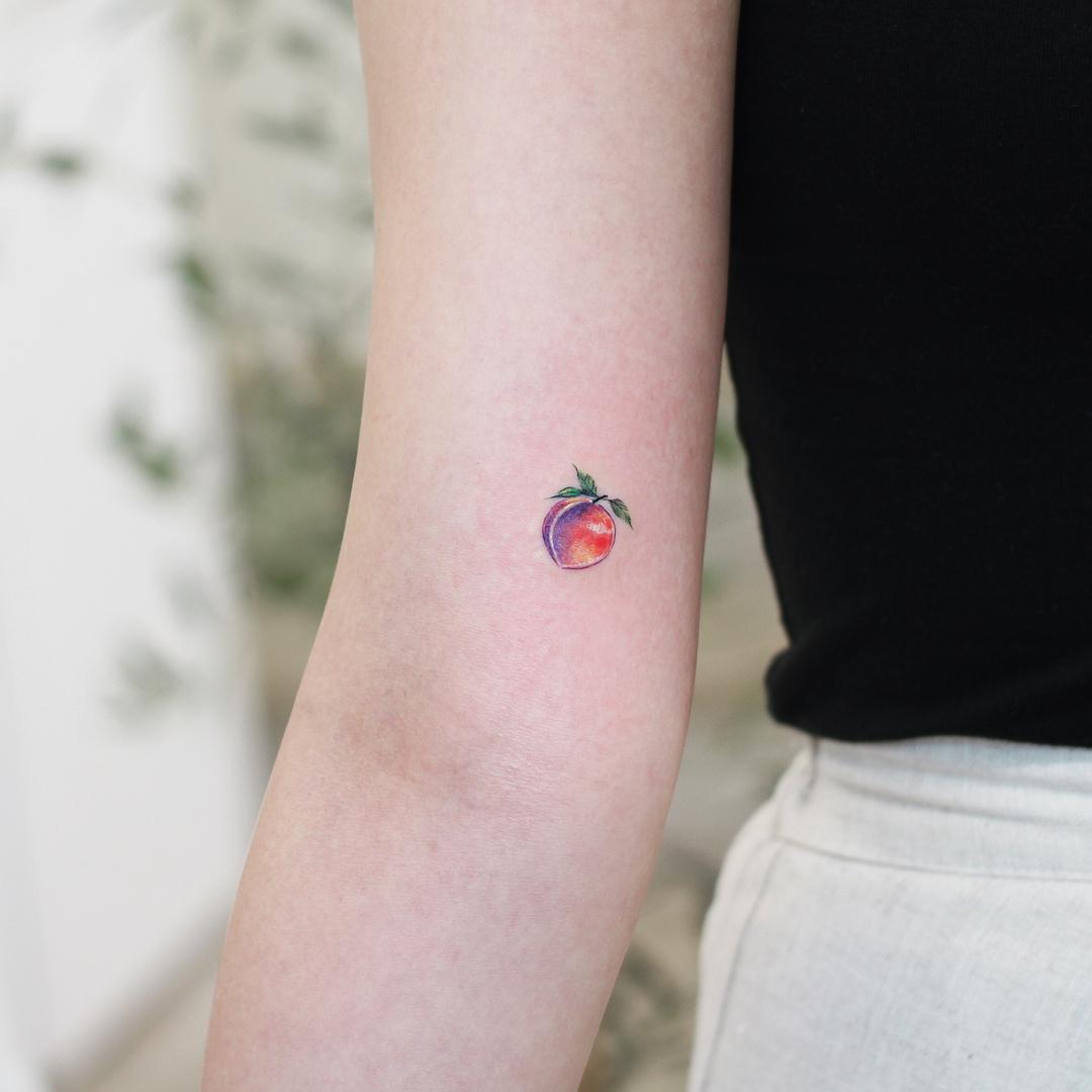 Tiny plum tattoo by @vane.tattoo_