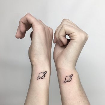 Matching Saturn tattoos by @isaarttattoo