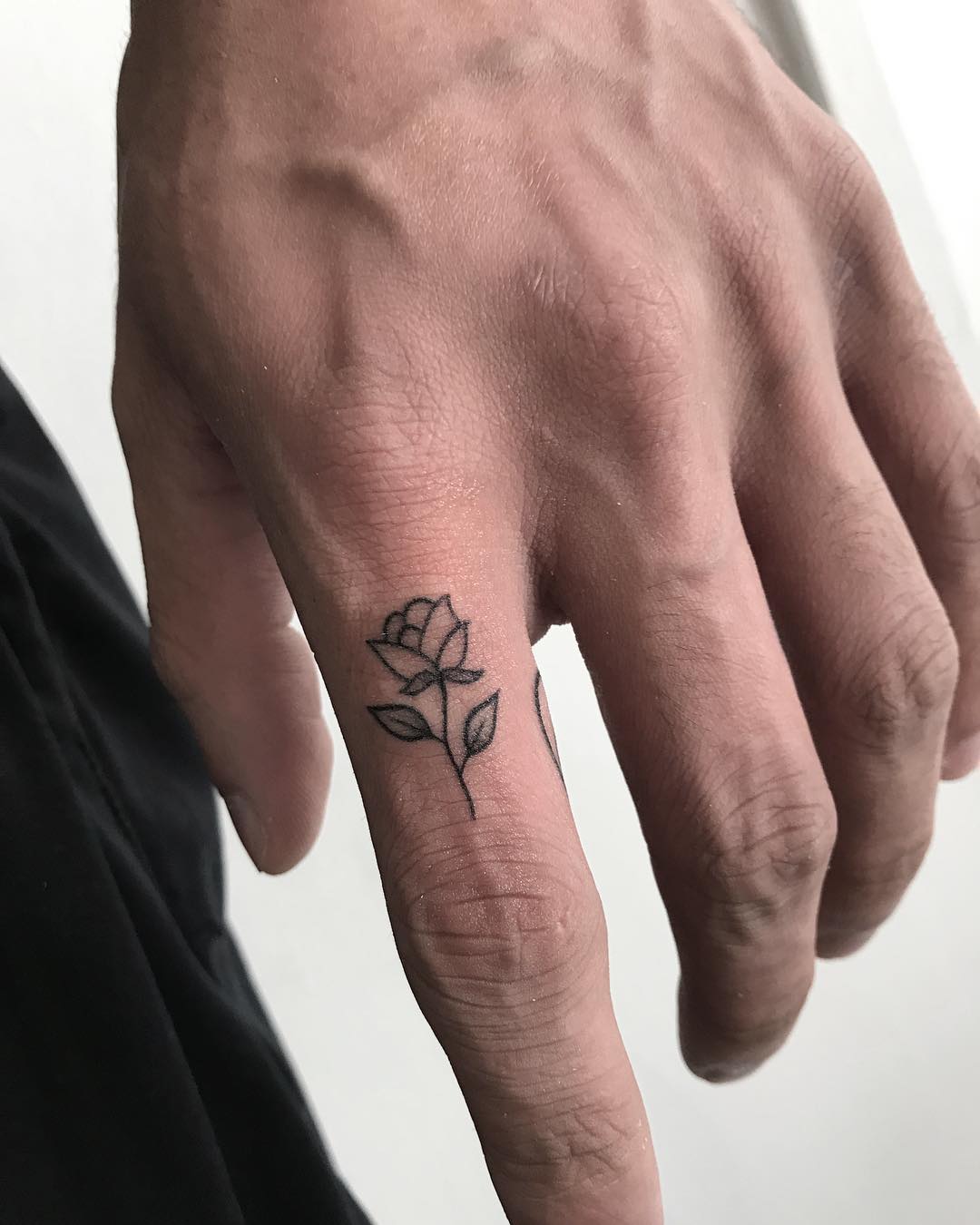 Hand poked sword tattoo on the left index finger.