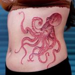 Red Octopus Tattoo On A Rib By @oozy_tattoo