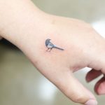 Tiny Magpie Sitting On A Scar by @wittybutton_tattoo