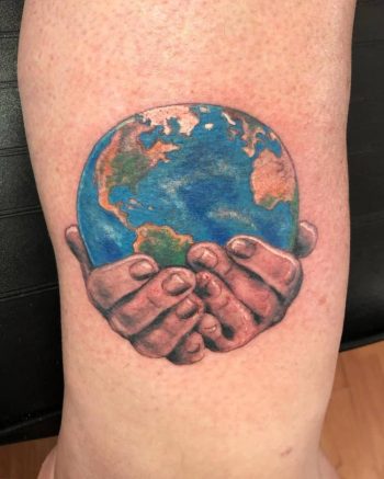 Hands Holding Earth Tattoo by @slingerstattoo